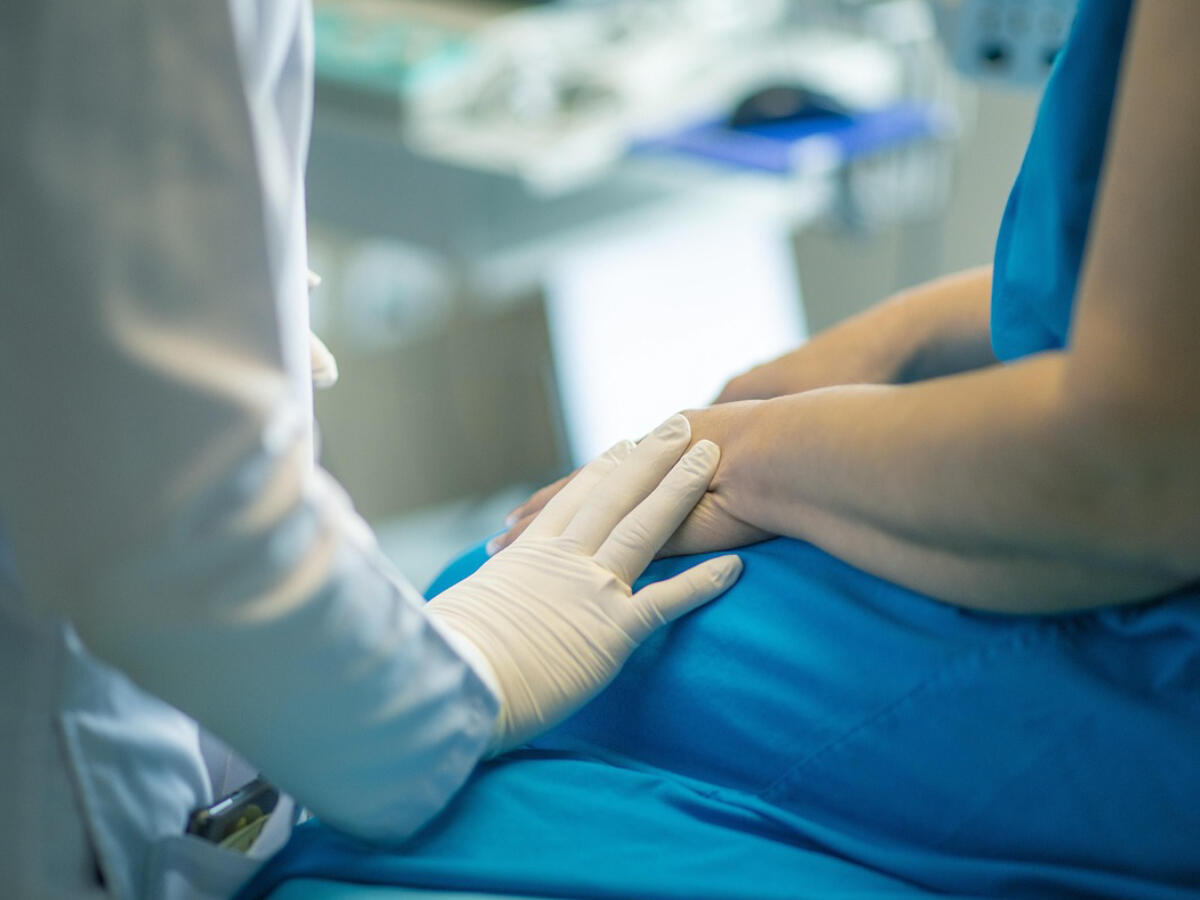 Physician providing supportive care during a pain management consultation Physician providing supportive care during a pain management consultation
